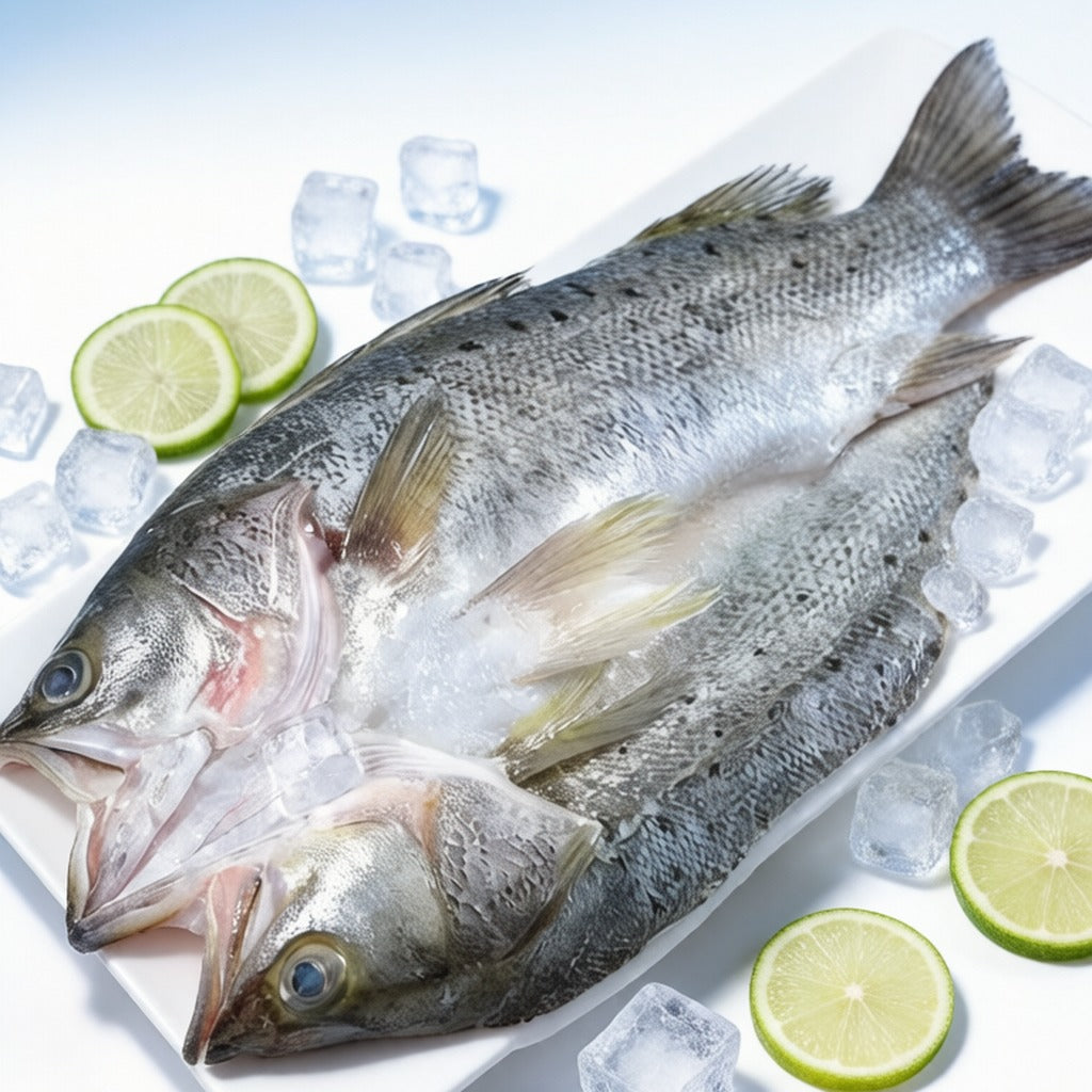 Whole sea bass on ice with lime